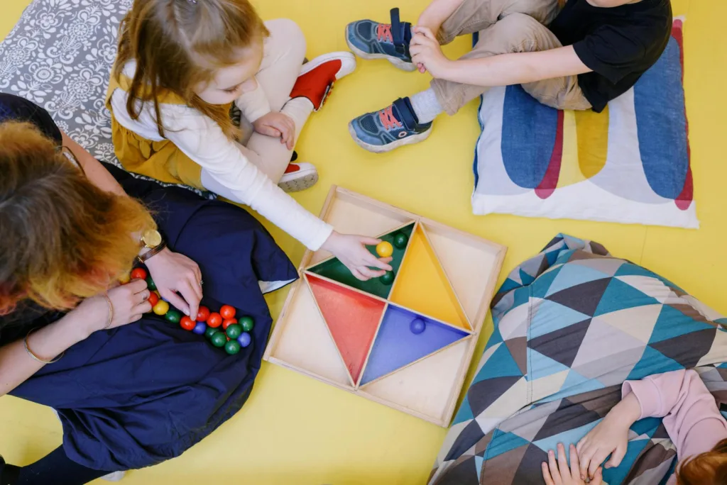 Kids engaged in playful learning with colorful toys in a vibrant playroom setting.