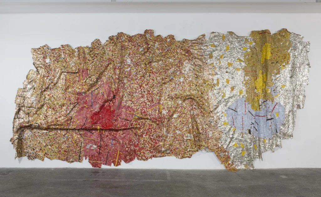 Famous Art with Cultural Themes: 15 Works to Explore Identity, Heritage, and Belonging 19 Gravity and Grace 2010 Aluminium liquor bottle caps and copper wire 500 x 1120cm Photo courtesy Susan Vogel